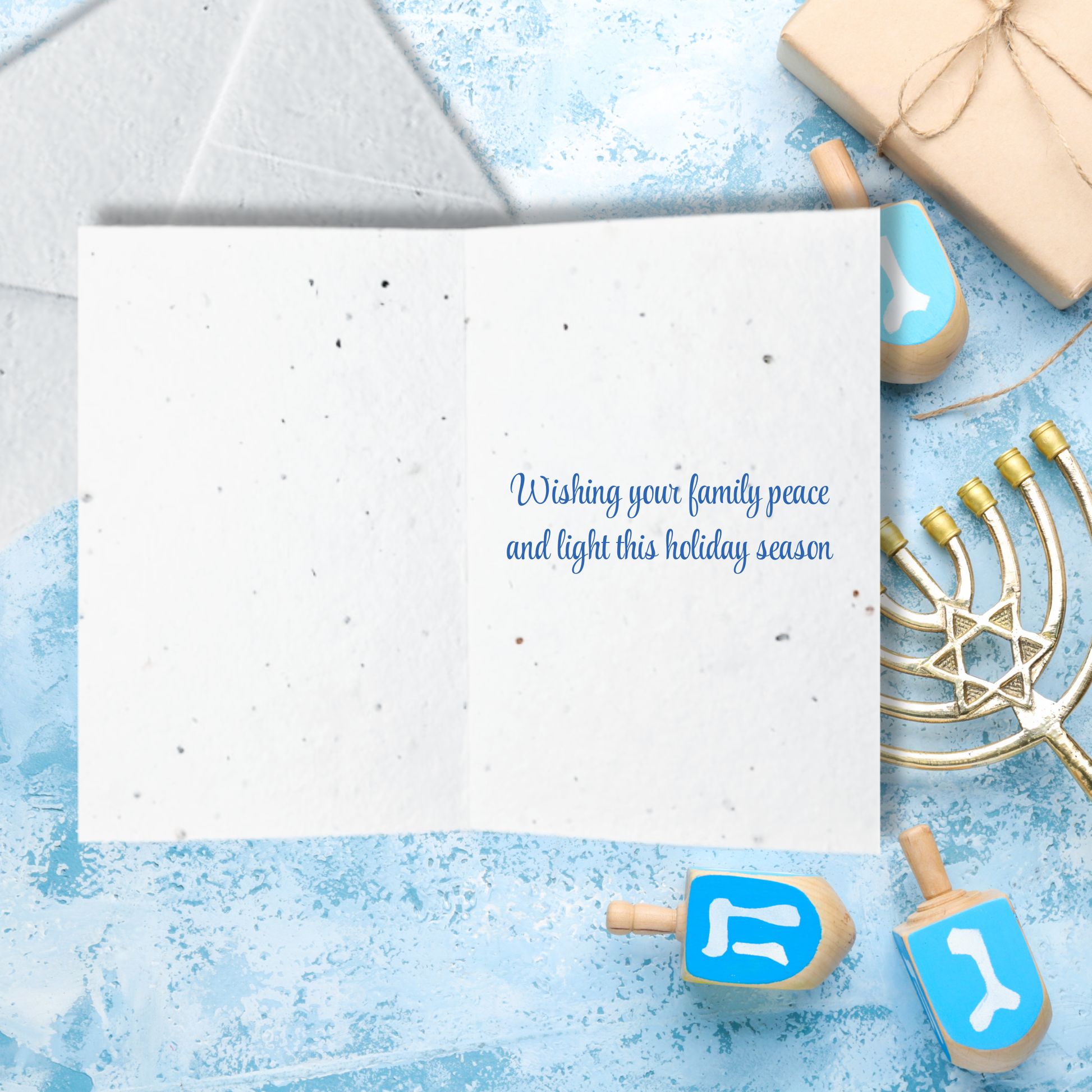 Hanukkah card with text 'wishing your family peace and light this holiday season' inside