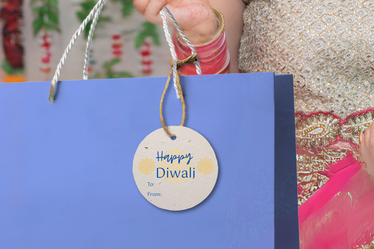 Woman holding a blue gift bag with a 'Happy Diwali' tag against a colorful background