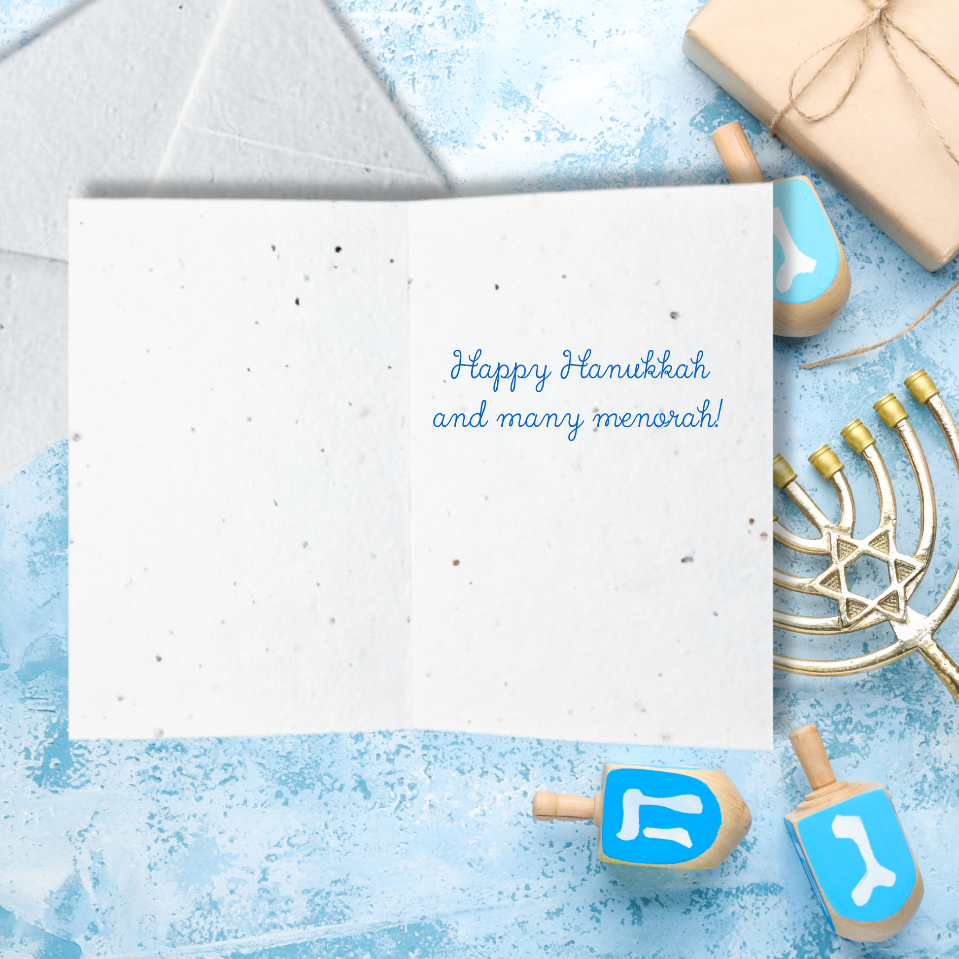 Hanukkah card with 'Happy Hanukkah and many menorah!' text inside