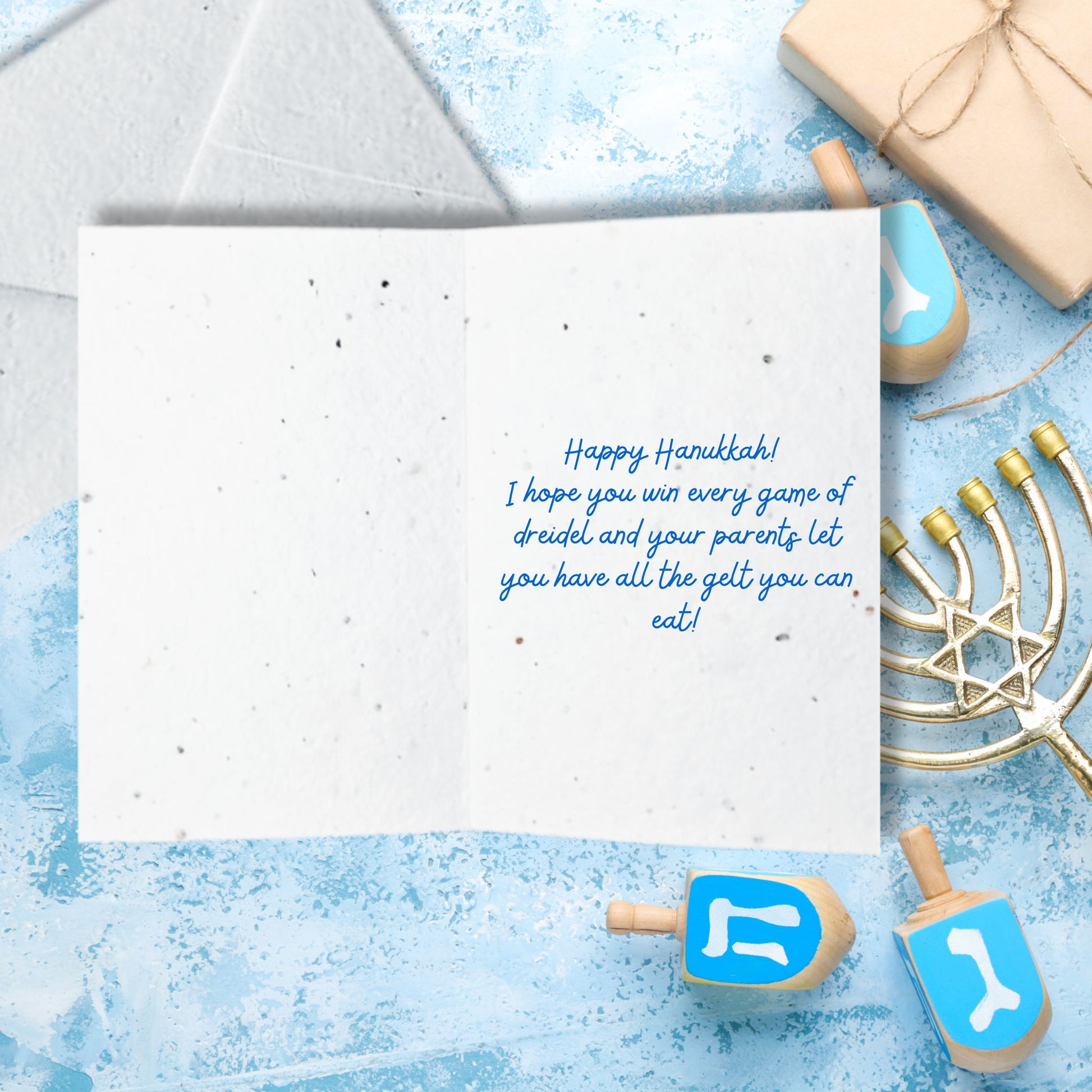 Hanukkah card with blue text 'happy Hanukkah I hope you win every game of dreidel and your parents let you have all the gelt you can eat!'