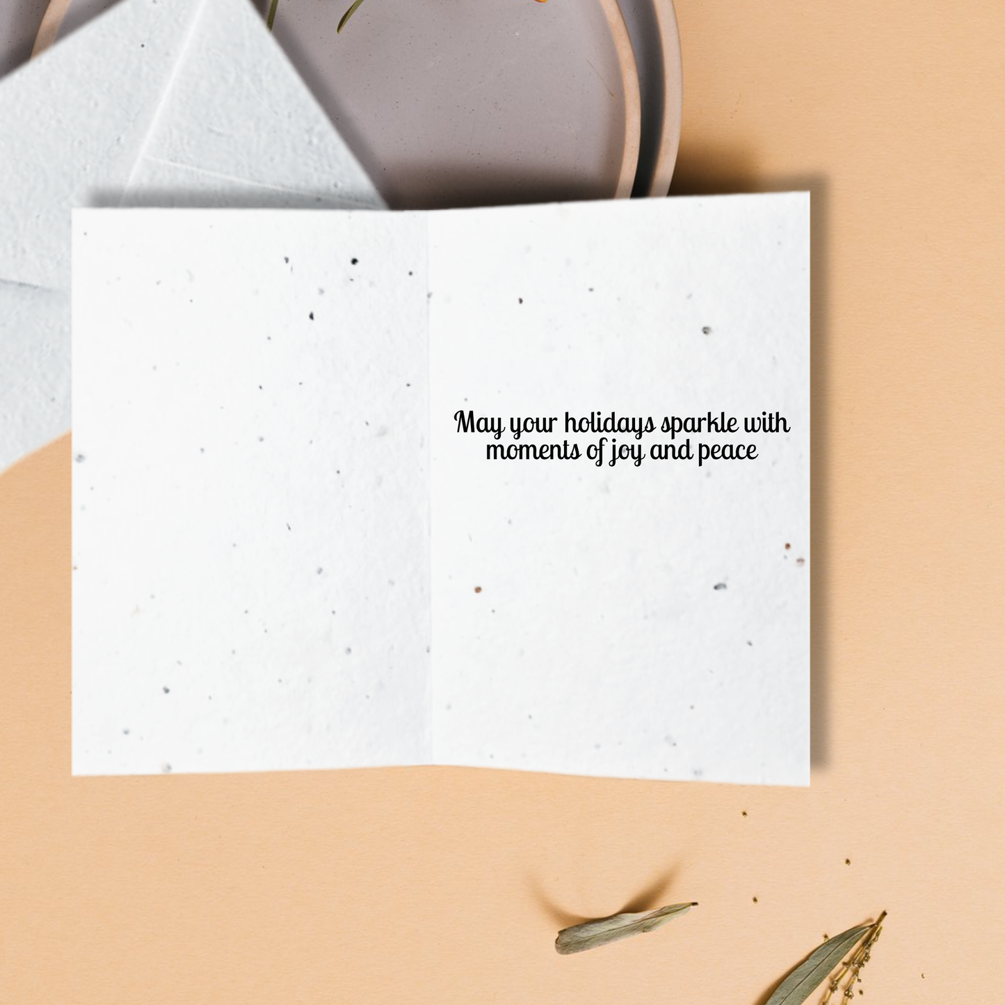 White card with text 'may your holidays sparkle with moments of joy and peace'