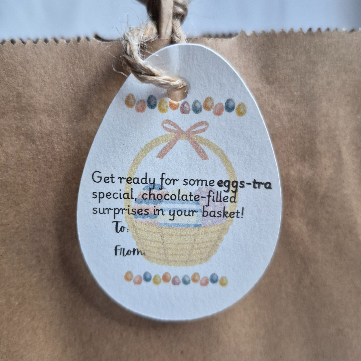 Easter egg-shaped tag with illustration of a basket and eggs