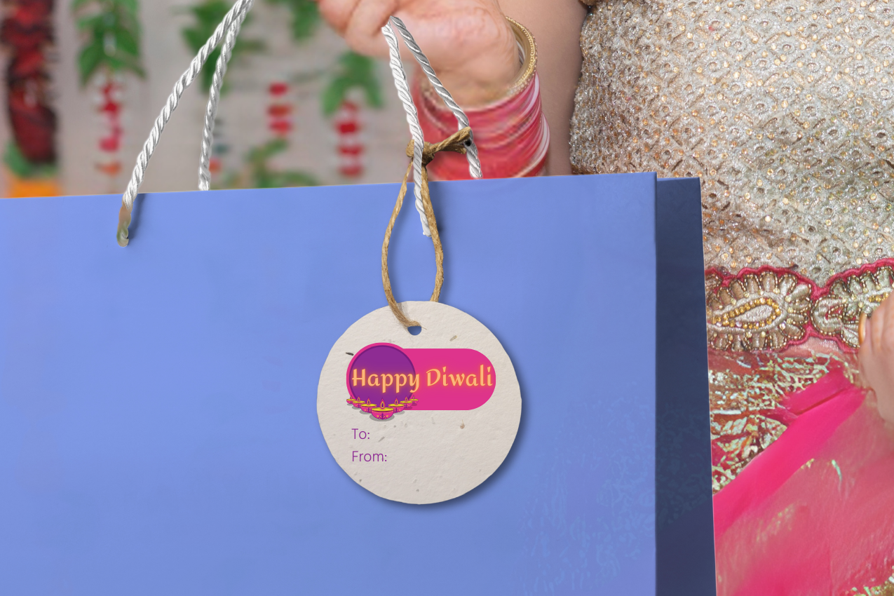 Woman holding a blue gift bag with a 'Happy Diwali' tag against a colorful background