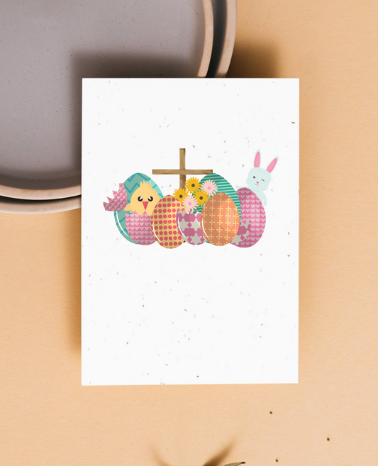Greeting card with Easter-themed illustrations of bunnies, a cross and Easter eggs on a beige background