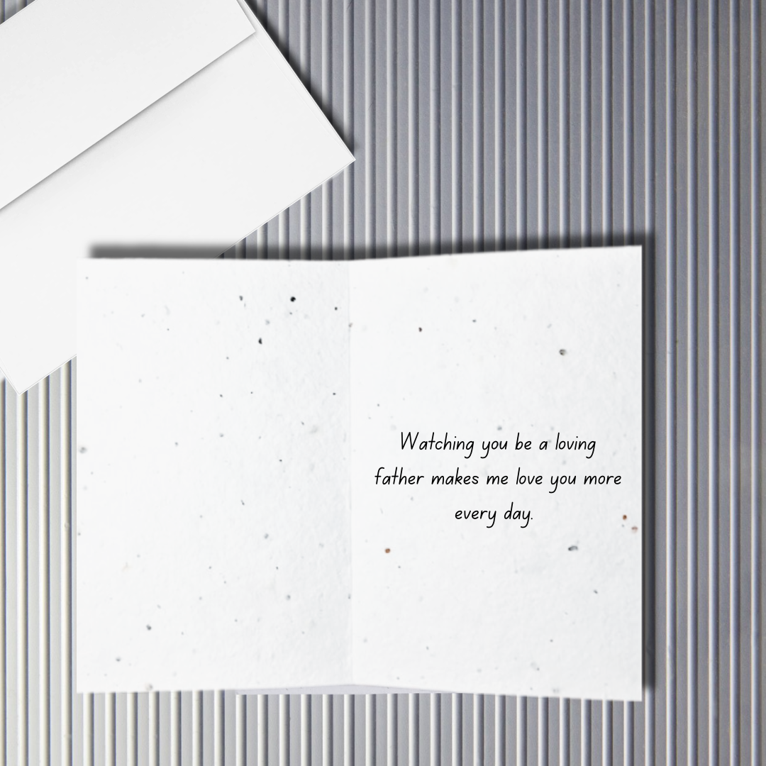 Inside a Father's Day greeting card with  ' Watching you be a loving father makes me love you more every day' text on a textured surface