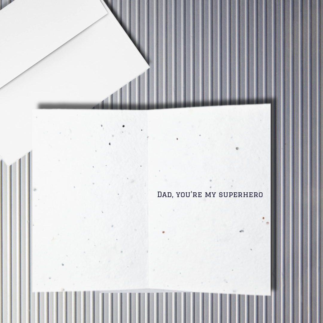 Inside a Father's Day Greeting card with 'Dad, you're my superhero' text on a textured white background