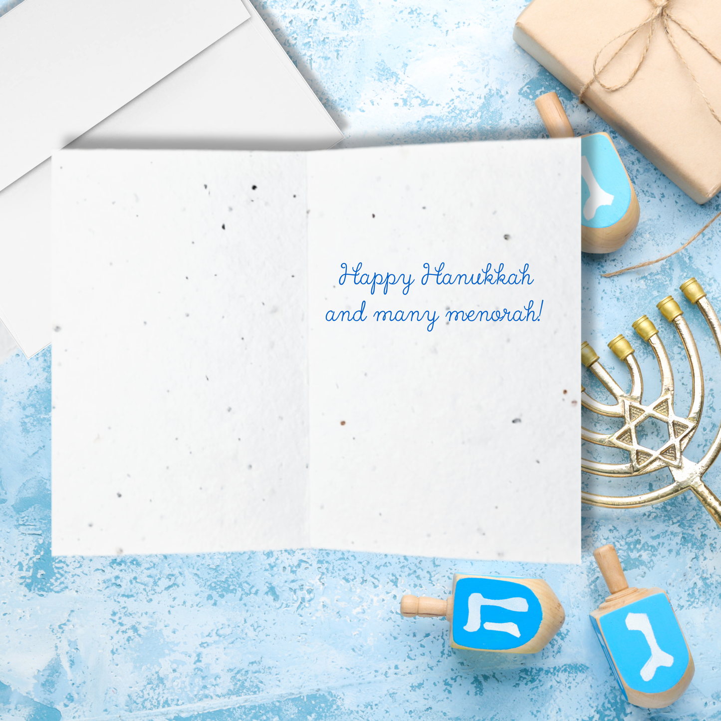  Inside Hanukkah seed paper card with text ' Happy Hanukkah and many menorah!'