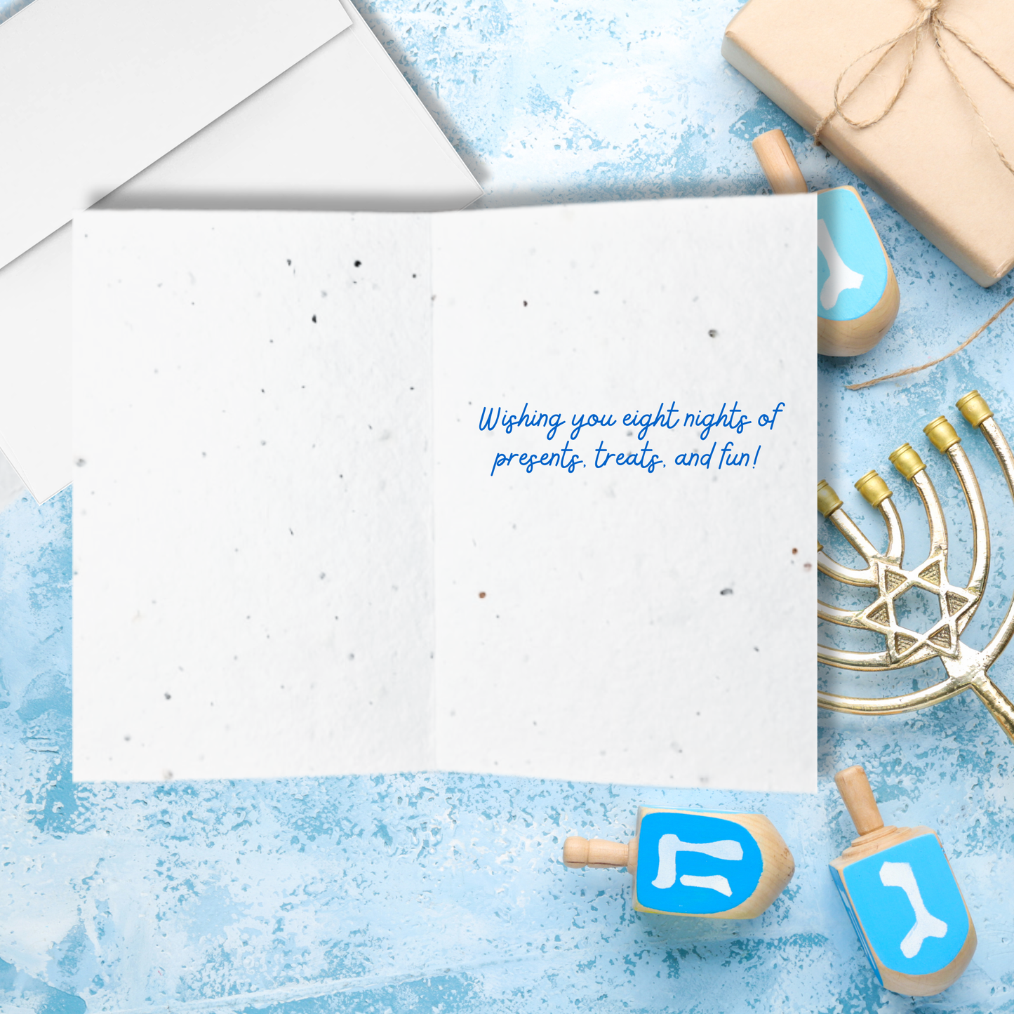 Inside Hanukkah seed paper card with text 'wishing you eight nights of presents treats and fun!'