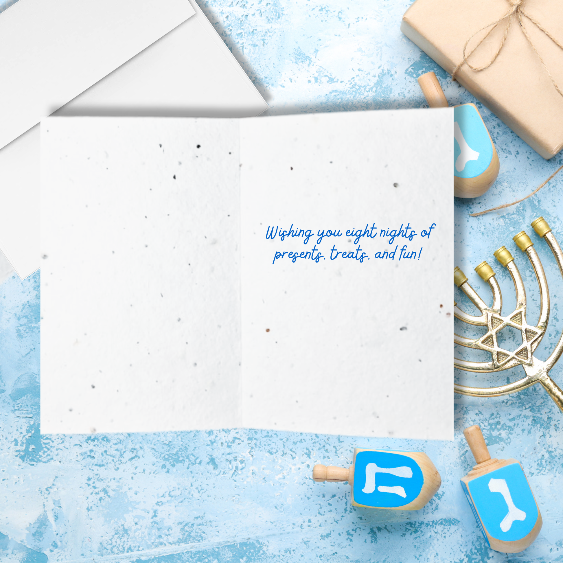 Inside Hanukkah seed paper card with text 'wishing you eight nights of presents treats and fun!'