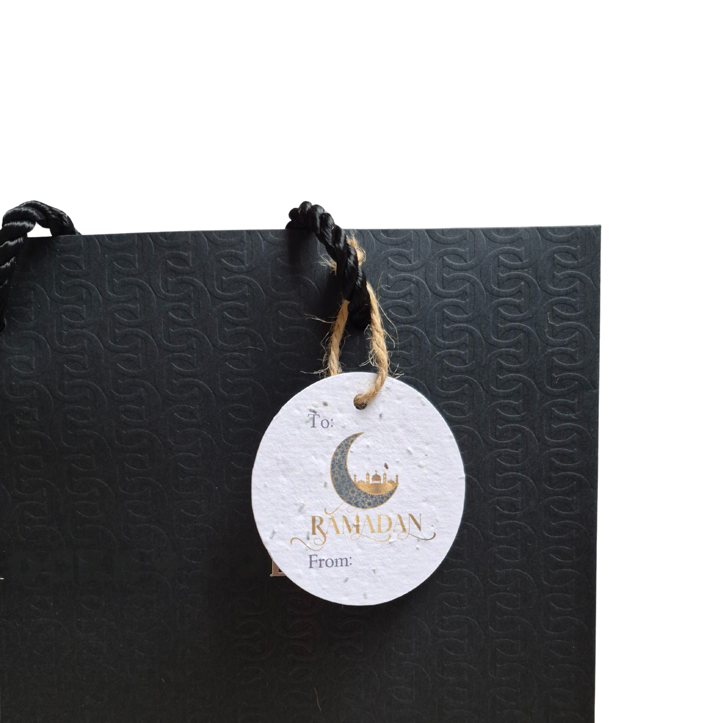Black gift bag with a 'Ramadan' moon and mosque  on a seed paper gift tag that is eco-friendly