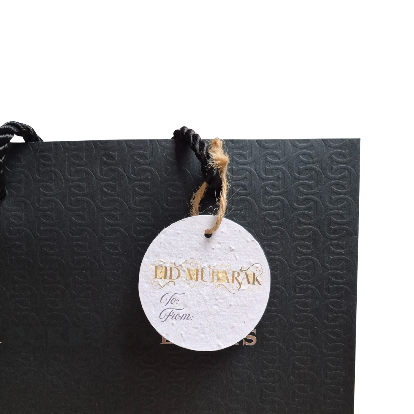 Black gift bag with 'Eid Mubarak'  text on a seed paper gift tag that is eco-friendly