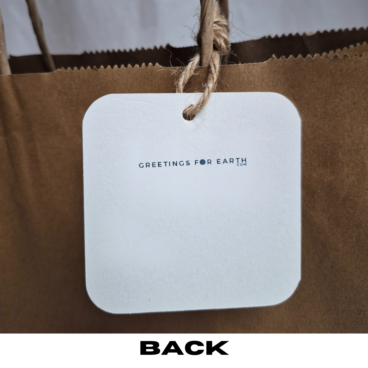 Rear of square recycled paper gift tag featuring 'Greetings for Earth.com' text.