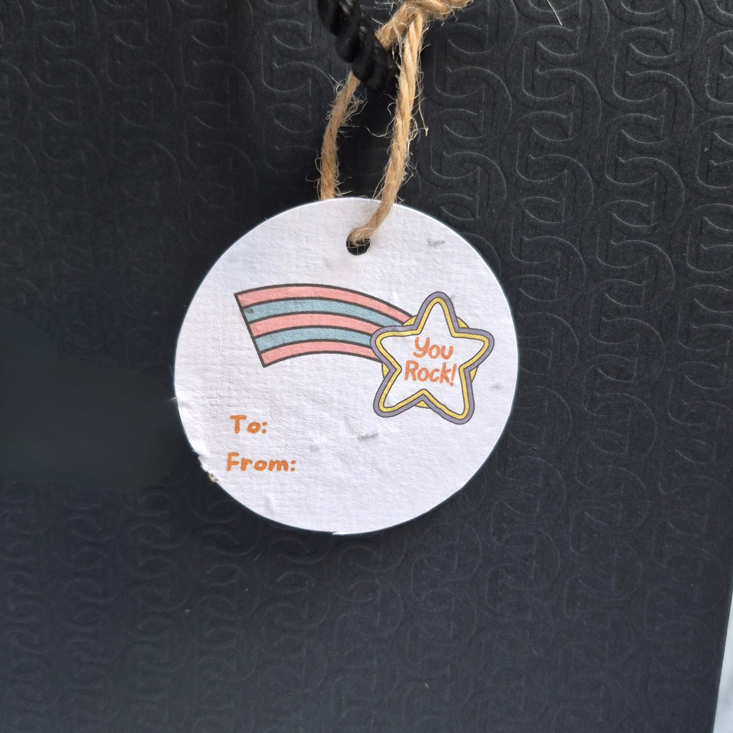 Round congratulations gift tag made with seed paper with rainbow and star with 'you rock' design