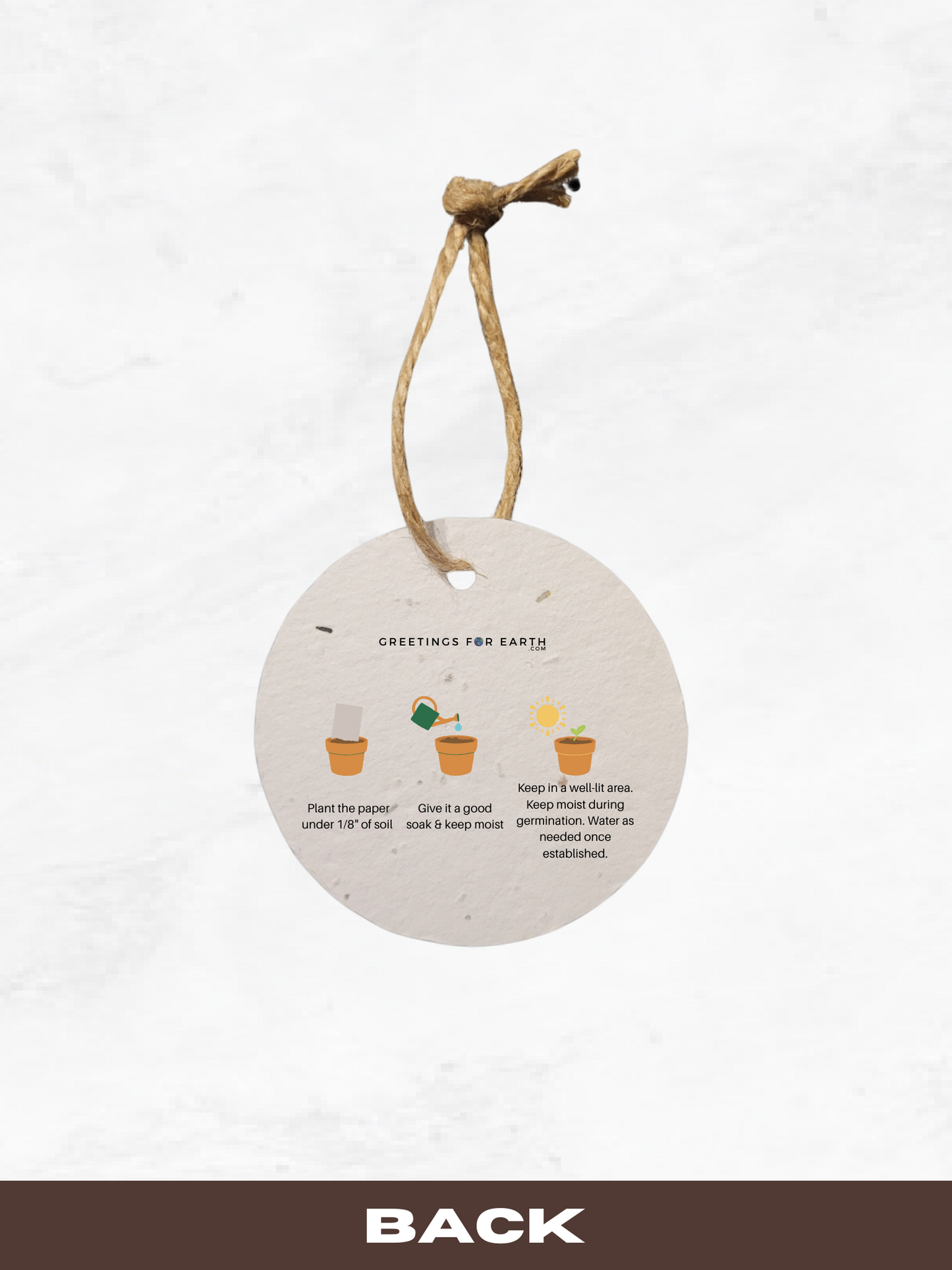 Round hanging plantable paper tag with planting instructions on a white background