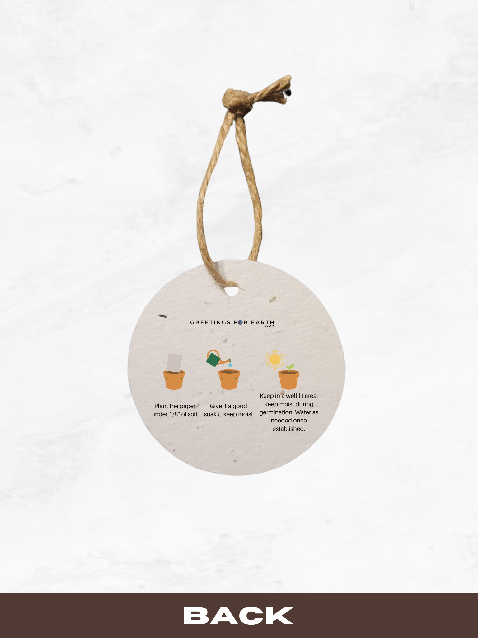 Round hanging plantable paper tag with planting instructions on a white background