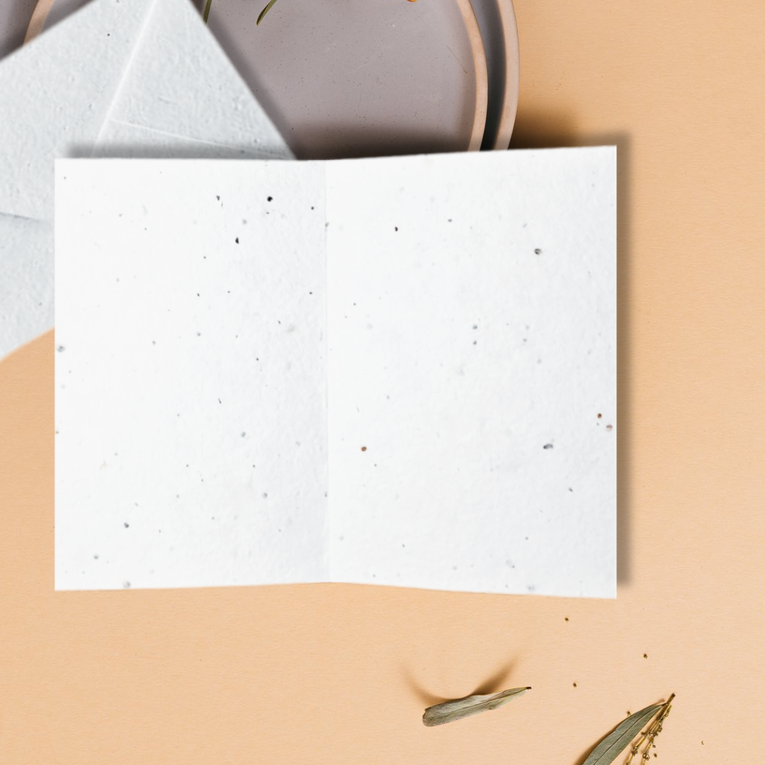 White textured blank inside card on a beige surface with a light gray envelope