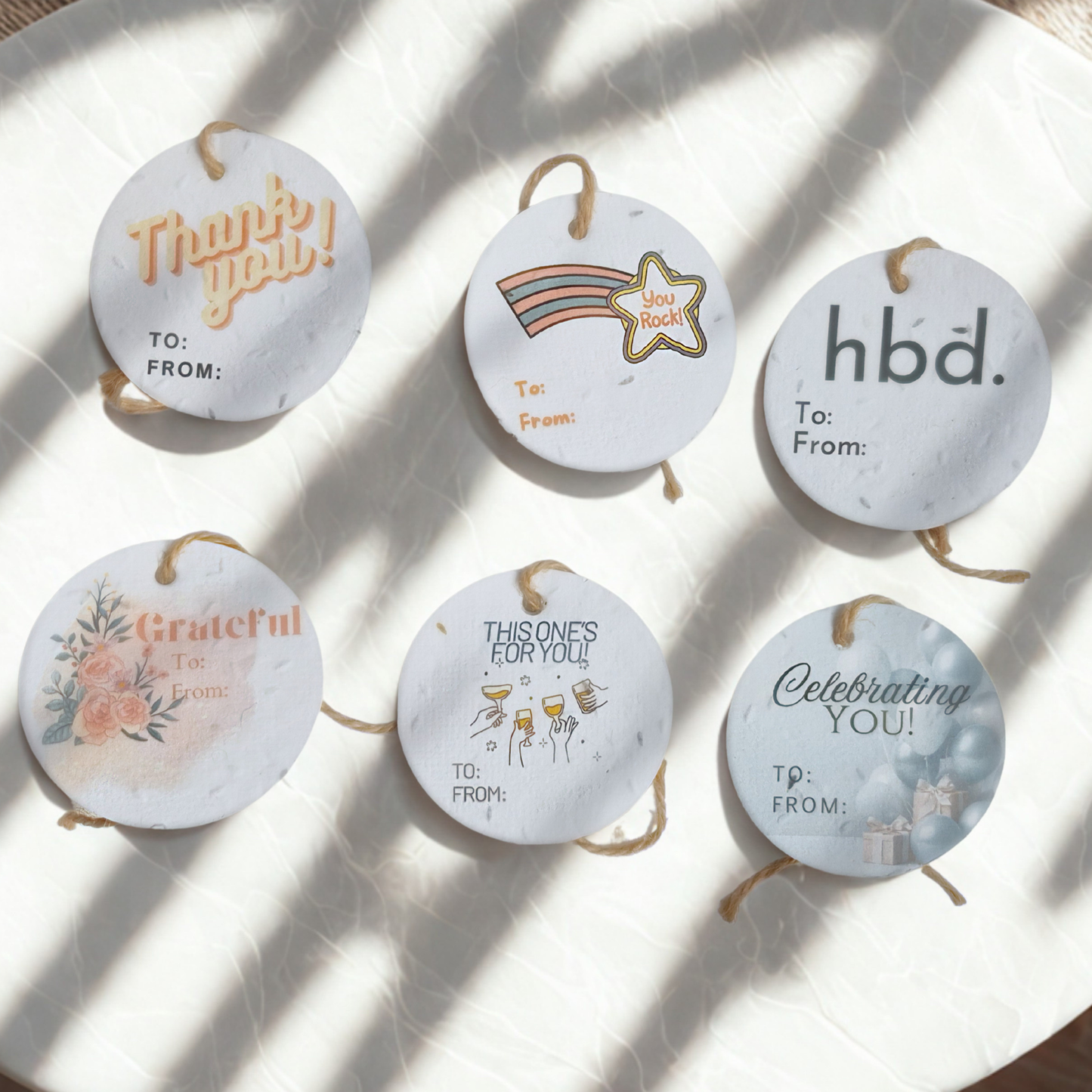 Set of 6 round seed paper gift tags with thank you, congrats and birthday designs 