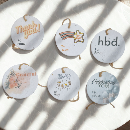 Set of 6 round seed paper gift tags with thank you, congrats and birthday designs 