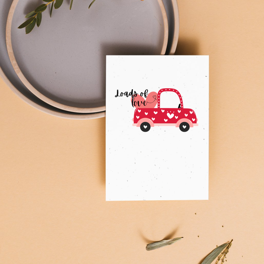 Valentine's day plantable card with a red truck that has a load of hearts illustration and 'Loads of Love' text 